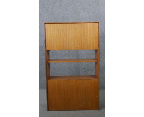 A vintage teak G-Plan wall unit with cupboards and open shelves. H.127 W.76 D.26CM 