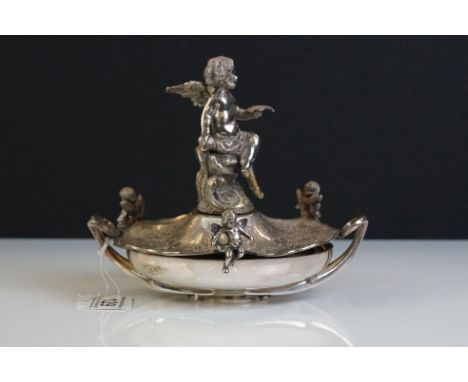 A Victorian silver plated table centrepiece with a winged cherub holding a butterfly above three shaped dishes, h:12cm, toget