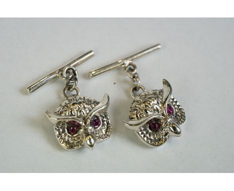 A pair of silver owl head cufflinks with ruby eyes 