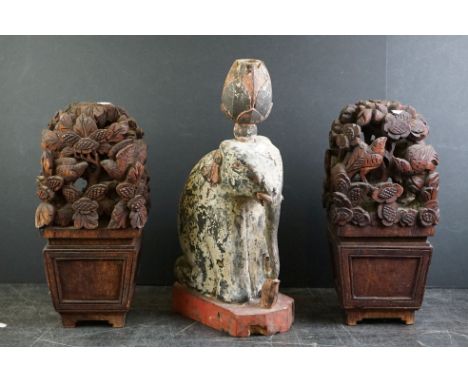 Pair of South East Asian carved wooden flower displays, 32cm high, together with a painted carved wooden candlestick modelled