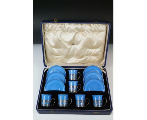 Boxed Shelley Blue glazed coffee set to include six coffee cans in silver hallmarked handled mounts (makers Adie Brothers Ltd