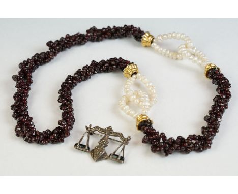 A garnet and natural pearl necklace together with a white metal marcasite brooch in the form of scales. 