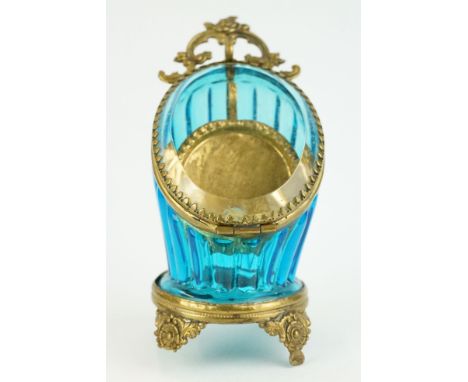 Late 19th century blue glass and brass pocket watch display case, raised on four cast feet, rose bud and scroll surmount, hei