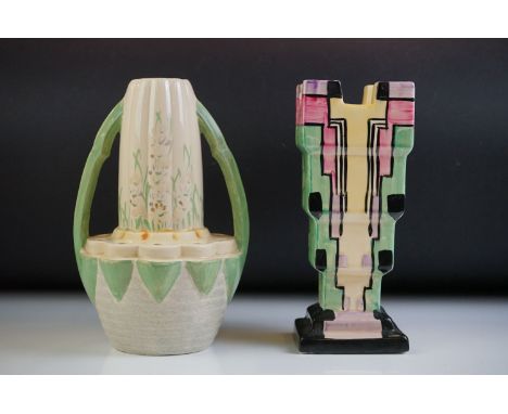 Myott, Son &amp; Co Art Deco 'Chimney' shaped vase, with a tiered geometric polychrome design on a black ground stepped base,