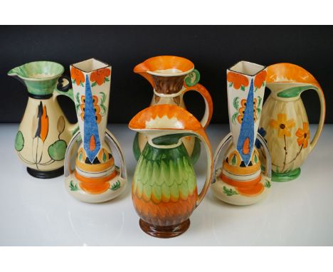 Four Myott, Son &amp; Co hand painted Art Deco footed jugs, decorated with colourful floral, foliate and geometric designs on
