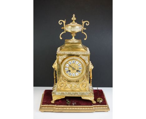 Antique French Brass Mantel Clock, with enamelled roman numerals on a brass dial, bevelled glass front door, applied scrollin