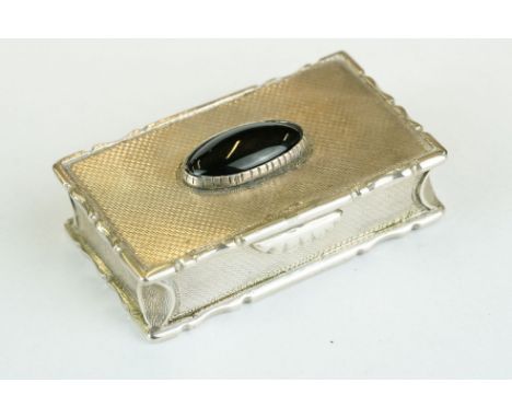 George IV silver snuff box, the engine turned hinged lid set with black onyx oval cabochon, cast stylised pie crust border, m