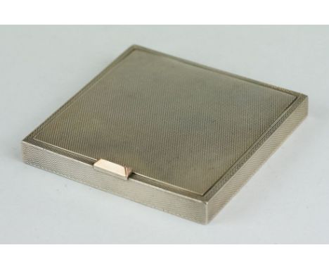 Dunhill silver compact, engine turned hinged lid and body, 14ct rose gold thumb-piece, the lid opening to reveal a mirror and