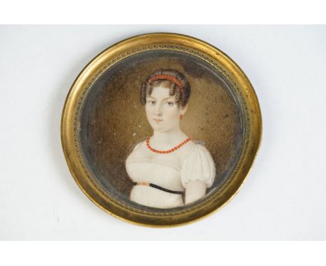 19th century English School, portrait miniature of a young woman wearing a coral headband and necklace, circular, 6.5cm diame