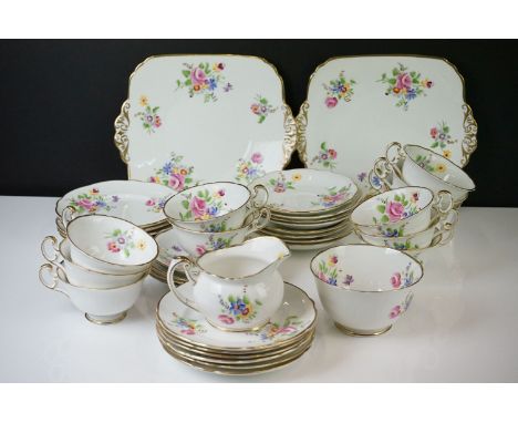 Early 20th Century Hand Painted tea service with floral design on a white ground and gilt rims, to include 12 teacups &amp; s