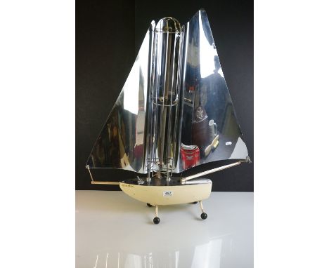 Mid 20th Century heat lamp modelled as a yacht, with an aluminium sail and iron base, measures 78cm high 