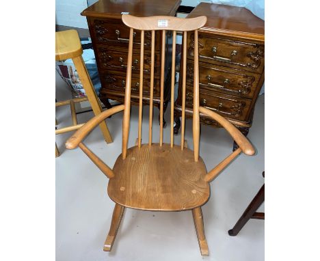 An Ercol light elm stick back rocking armchair 