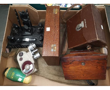 A vintage Bell and Howell 605 cine camera; a cased brush set; a 19th century rosewood tea caddy; a Russian doll; an African c