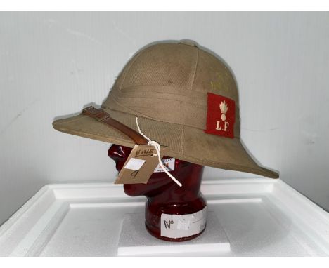 Lancashire Fusiliers, a tropical pith helmet, WWII period, red cloth badge, and stand 