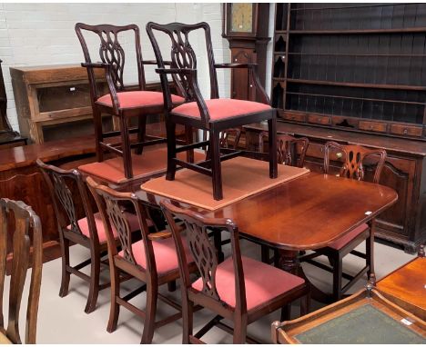 A mahogany reproduction dining suite comprising extending table and 8 (4 + 4) Chippendale style chairs 