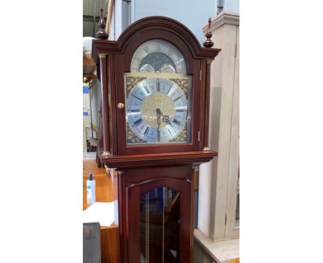 A reproduction Georgian style mahogany longcase clock with arch top, brass dial with moonphase and triple weight striking mov