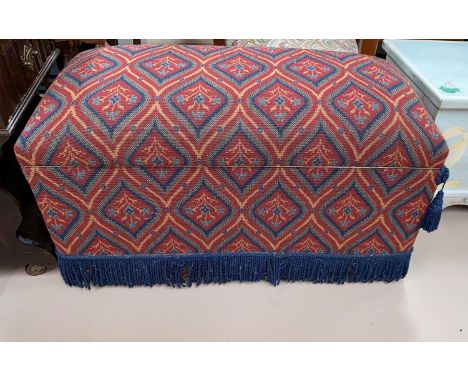An ottoman in red pattern tapestry upholstery 