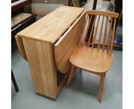 A modern lightwood drop leaf kitchen table and 4 stick back chairs 