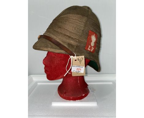 Lancashire Fusiliers, an early 20th century tropical pith helmet, red cloth badge and stand 