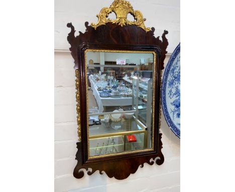 A wall mirror in parcel gilt Chippendale style frame 