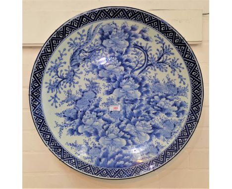 A Chinese large ceramic charger decorated with flowers and birds, patterned rim, diameter 56 cmHairline crack on right hand s