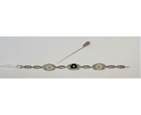 An Art Deco white metal filigree oval link bracelet stamped '14K' tests as 10 / 12 carats, set with 3 small diamonds, 8gm,  a