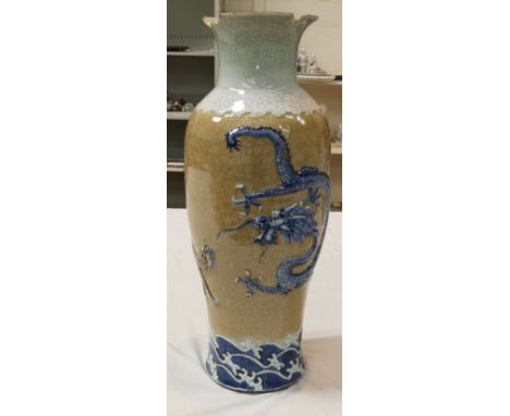 A large Chinese crackle glaze floor vase decorated with a dragon and tiger in relief, seal mark to base (vase rim damaged) he