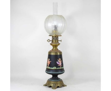 A 19th century brass oil lamp, the porcelain body painted with a continuous frieze of cherubs, on a black ground, having an e