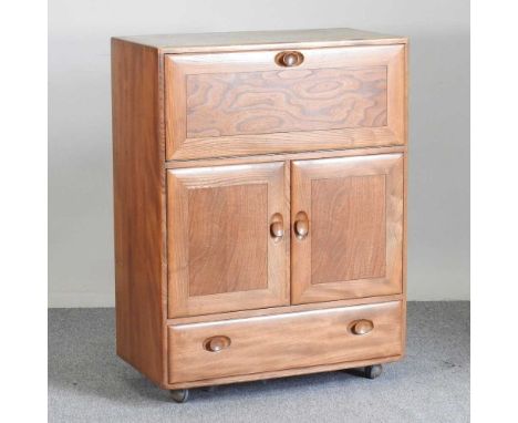 A 1970's Ercol light elm Windsor cabinet, model 469, with a hinged fall82w x 43d x 110h cm