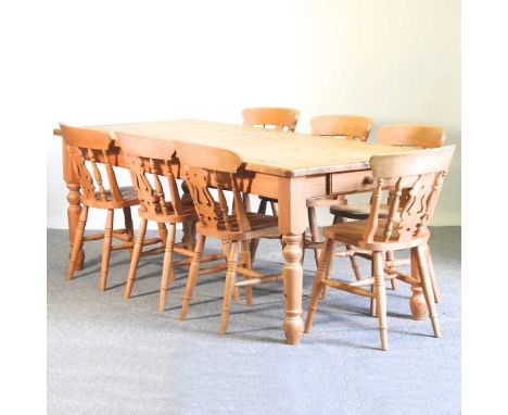 A modern pine kitchen table, on turned legs, together with seven beech splat back dining chairs (8)214w x 90d x 77h cmOverall