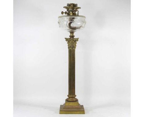 A large Victorian brass oil lamp, in the form of a Corinthian column, with a clear cut glass reservoir, 71cm high