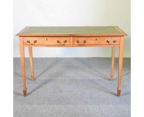 An Arts &amp; Crafts light oak writing table, with a leather top, on square legs122w x 60d x 76h cm