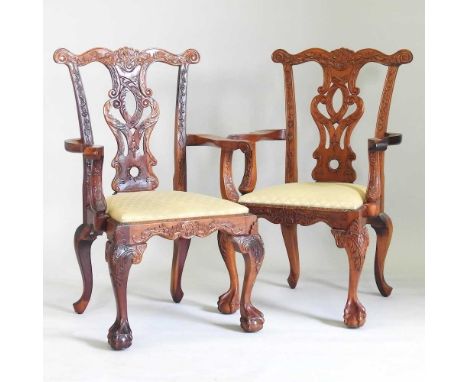 A pair of late 20th century Chippendale style carved hardwood elbow chairs, on claw and ball feet (2)67cm wide