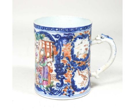 An 18th century Chinese porcelain mug, reserved with panels of figures, with a moulded dragon handle, 12cm highCrack running 