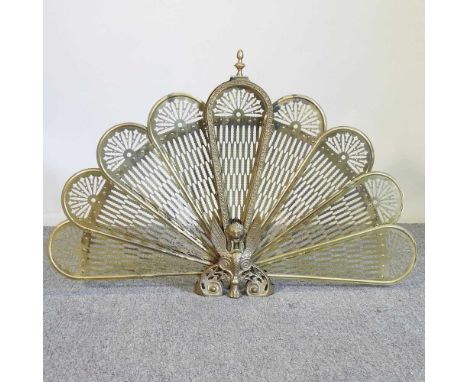 An ornate brass folding firescreen, of peacock design, 62cm high