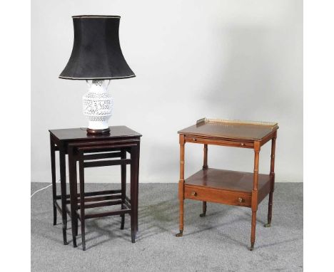 An early 20th century brass mounted side table, together with a nest of occasional tables and a reticulated pottery table lam