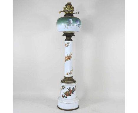 A porcelain oil lamp and shade, with floral decoration, 69cm high