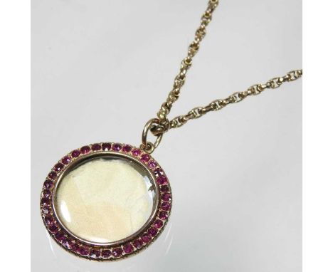 An unmarked Victorian rose coloured pendant, with a ruby surround, 30mm diameter, on a gold box link chain, 6.8g, 42cm longOv