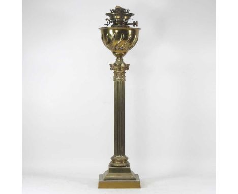 A 19th century brass oil lamp, in the form of a fluted Corinthian column, on a stepped base, having a wrythen brass font and 