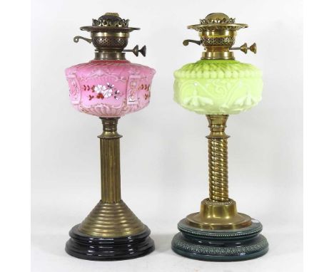 A 19th century brass oil lamp, with a pink opaline glass reservoir, together with another green (2)
