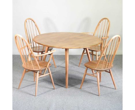 A 1970's Ercol light elm dining suite, comprising a circular drop leaf dining table, 128cm wide and a set of four stick back 