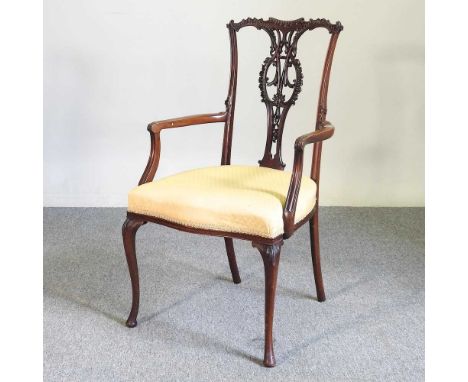 An Edwardian carved mahogany elbow chair, on cabriole legs55w x 48d x 96h cmOverall complete and usable. The frame is complet