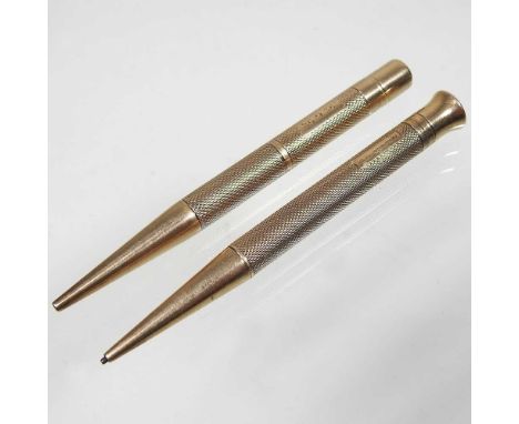 An early 20th century carat gold propelling pencil, with engine turned decoration, stamped THE MASCOT REGt. and another simil