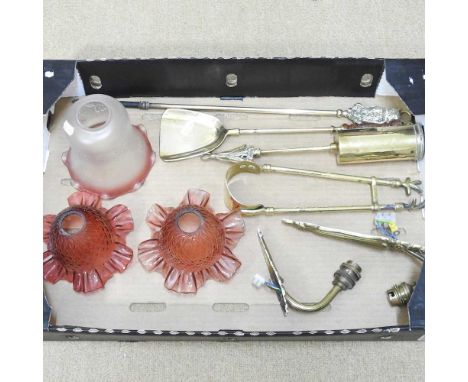 A pair of frilled glass light shades, together with another and a collection of brass fire tools