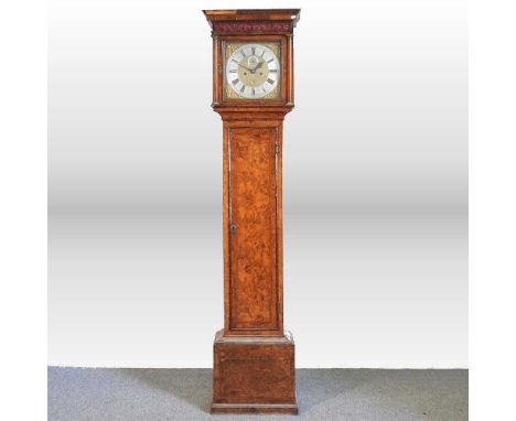 A Queen Anne burr walnut and feather banded cased longcase clock, the twelve inch brass dial, with silvered chapter ring, sig