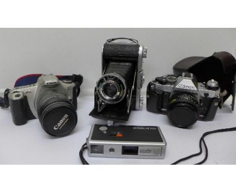 Four cameras including Canon AE1, EOS360 and Minolta Autopak 470 camera