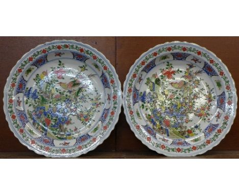 A pair of Chinese famille verte chargers, bearing Kangxi mark verso, 46cm