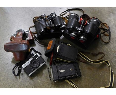 A pair of Russian binoculars, a pair of Boots 10x50 binoculars, a Zeiss Ikon folding camera, cased, etc.