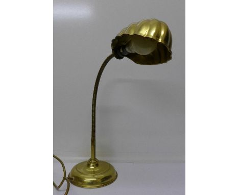 A brass anglepoise desk lamp