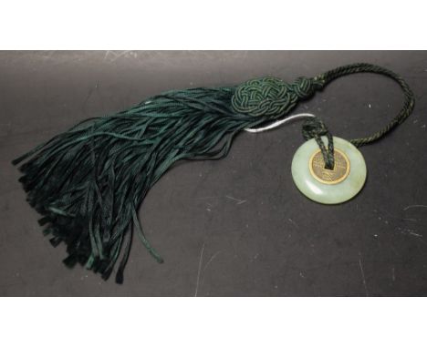 A Chinese jade disc with silk tassel